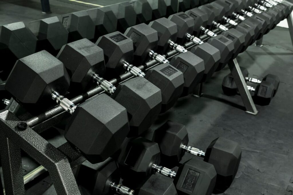 hex dumbbells on rack in gym sports equipment store